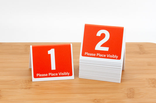 3in tall tent style orange table numbers for use in fast food chain restaurants and quick serve restaurants.